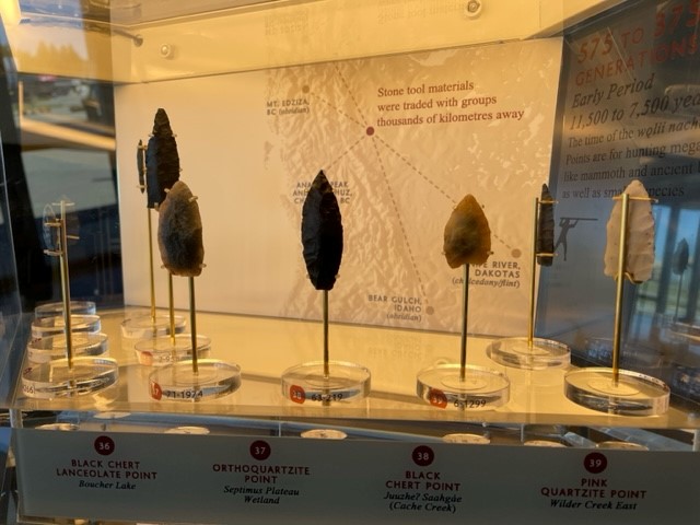Display stand of stone knapped tools, mounted on polestands.