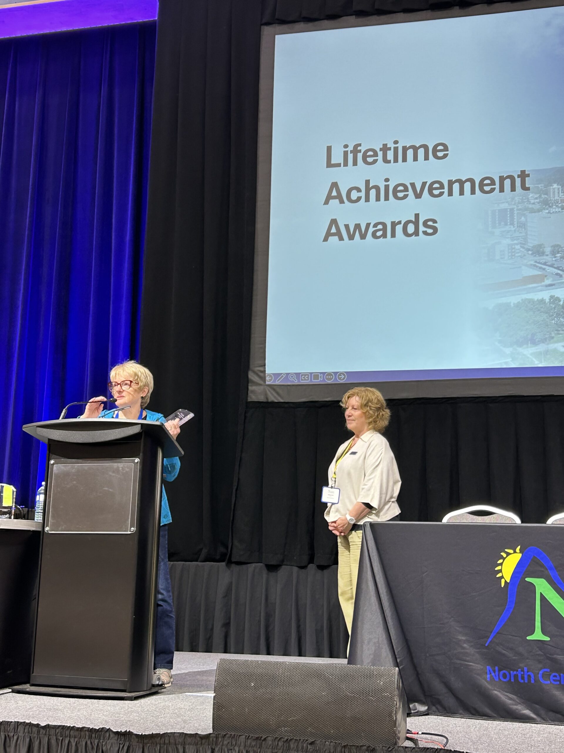 Mayor Joan Atkinson at a podium accepting a Lifetime Achievement award